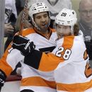 Philadelphia Flyers' Maxime Talbot (27) celebrates his first-period goal with teammate Claude Giroux (28) during Game 2 of an opening-round NHL hockey playoff series against the Pittsburgh Penguins in Pittsburgh Friday, April 13, 2012. (AP Photo/Gene J. Puskar)