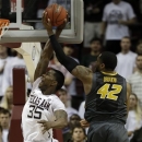 Missouri's Alex Oriakhi (42) tries to block a shot by Texas A&M's Ray Turner (35) during the second half of an NCAA college basketball game on Thursday, Feb. 7, 2013, in College Station, Texas. Texas A&M won 70-68. (AP Photo/Pat Sullivan)