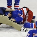 New York Rangers' Marc Staal is helped by a trainer after being injured during the third period of an NHL hockey game against the Philadelphia Flyers on Tuesday, March 5, 2013, in New York. The Rangers won the game 4-2. (AP Photo/Frank Franklin II)