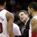 Louisville coach Rick Pitino, center, talks to Wayne Blackshear, left, during the second half of an NCAA college basketball game against South Florida on Saturday Jan. 12, 2013, in Louisville, Ky. At right is Peyton Siva. Louisville defeated South Florida 64-38. (AP Photo/Timothy D. Easley)