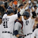 Detroit Tigers' Omar Infante, right, celebrates his three-run home run with Victor Martinez in the second inning of a baseball game against the Cleveland Indians Saturday, Aug. 31, 2013, in Detroit. (AP Photo/Duane Burleson)