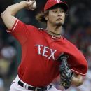 Texas Rangers starting pitcher Yu Darvish (11), of Japan, throws against the Oakland Athletics during the first inning of a baseball game Wednesday, May 16, 2012, in Arlington, Texas. (AP Photo/LM Otero)
