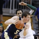 Georgia Tech's Daniel Miller (5) drives the ball on Miami's Julian Gamble during the first half of an NCAA college basketball game in Coral Gables, Fla., Wednesday, March 6, 2013. (AP Photo/Luis M. Alvarez)