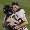 Detroit Tigers starting pitcher Justin Verlander hugs catcher Alex Avila after the Tigers beat the Oakland Athletics 6-0 in Game 5 of an American League division baseball series in Oakland, Calif., Thursday, Oct. 11, 2012. (AP Photo/Eric Risberg)
