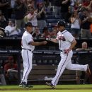 Atlanta Braves' Chipper Jones, right, is congratulated by coach Brian Snitker while rounding third base after hitting a two-run home run against the Arizona Diamondbacks during the sixth inning of a baseball game on Wednesday, June 27, 2012, in Atlanta. (AP Photo/John Amis)