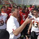 In this April 21, 2012, photo, Maryland football coach Randy Edsall, center, talks with his players after the team's annual Red-White scrimmage in College Park, Md. In his first season as the team's coach, Edsall won only one Atlantic Coast Conference game and had two dozen players leave the program. He attributed those shortcomings to the problems that come with instilling a new philosophy that stresses discipline, teamwork and academics. Edsall is confident a solid recruiting class, the resolve of his remaining players and a new football field will result in noticeable improvement in 2012. (AP Photo/Patrick Semansky)