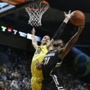 Oregon's Waverly Austin (20) swats away a shot by Colorado's Jeremy Adams (31) during the first half of an NCAA college basketball game at Matthew Knight Arena in Eugene, Ore. Thursday, February 7, 2013. (AP Photo/Brian Davies)