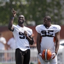 Cleveland Browns linebacker Barkevious Mingo, left, talks with defensive end Armonty Bryant during practice at the team's NFL football training facility in Berea, Ohio Wednesday, Aug. 21, 2013. Mingo sat out practice with a bruised lung. (AP Photo/Mark Duncan)