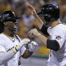 Pittsburgh Pirates' Andrew McCutchen, left, celebrates with Jordy Mercer after hitting a two-run home run off St. Louis Cardinals starting pitcher Tyler Lyons during the fifth inning of the second baseball game of a doubleheader in Pittsburgh, Tuesday, July 30, 2013. (AP Photo/Gene J. Puskar)