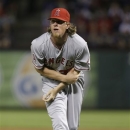 Los Angeles Angels starting pitcher Jered Weaver holds his arm and looks to the dugout after getting hit in the arm with a line drive during the sixth inning of a baseball game against the Texas Rangers Sunday, April 7, 2013, in Arlington, Texas.  Weaver left the game. (AP Photo/LM Otero)