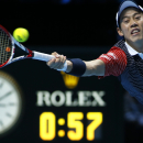 Japan's Kei Nishikori plays a return to Switzerland's Roger Federer during their singles ATP World Tour tennis finals match at the O2 arena in London, Tuesday, Nov. 11, 2014. (AP Photo/Alastair Grant)