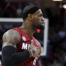 Miami Heat's LeBron James (6) reacts after scoring in the fourth quarter of an NBA basketball game against the Cleveland Cavaliers on Wednesday, March 20, 2013, in Cleveland. James scored a team-high 25 points in Miami's 98-95 win. (AP Photo/Tony Dejak)
