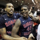 Robert Morris forward Mike McFadden (1) and forward Keith Armstrong (45) celebrate with fans following a 59-57 win over Kentucky during a first-round NIT college basketball game on Tuesday, March 19, 2013, in Coraopolis, Pa.(AP Photo/Don Wright)