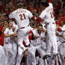 Cincinnati Reds' Todd Frazier (21) jumps onto home plate after hitting a walk off home run off Atlanta Braves relief pitcher Cristhian Martinez in the ninth inning of a baseball game, Wednesday, May 23, 2012 in Cincinnati. The Reds won 2-1. (AP Photo/Al Behrman)