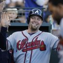 Atlanta Braves' Brian McCann, center, is greeted in the dugout after scoring on a Paul Janish triple during the sixth inning of a baseball game against the San Francisco Giants, Sunday, Aug. 26, 2012, in San Francisco. (AP Photo/George Nikitin)