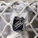 The NHL logo is seen on a goal at a Nashville Predators practice rink on Monday, Sept. 17, 2012, in Nashville, Tenn. The NHL locked out its players at midnight Saturday, the fourth shutdown for the NHL since 1992. (AP Photo/Mark Humphrey)