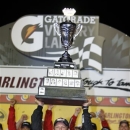 Matt Kenseth holds up the trophy in Victory Lane after winning the NASCAR Sprint Cup series auto race at Darlington Raceway, Saturday, May 11, 2013, in Darlington, S.C. (AP Photo/Mic Smith)