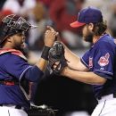 Cleveland Indians' Carlos Santana, left, congratulates pitcher Chris Perez after the Indians beat the Detroit Tigers 5-3 in a baseball game, Tuesday, May 22, 2012, in Cleveland. (AP Photo/Tony Dejak)