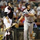 Atlanta Braves' Chipper Jones, right, watches his two-run home run along with Houston Astros catcher Chris Snyder, left, during the third inning of a baseball game Tuesday, April 10, 2012, in Houston. The Braves' Dan Uggla scored on Jones' homer. (AP Photo/David J. Phillip)