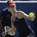 Alize Cornet, of France, returns a shot to Lucie Safarova, of the Czech Republic, during the third round of the 2014 U.S. Open tennis tournament, Friday, Aug. 29, 2014, in New York. (AP Photo/Frank Franklin II)