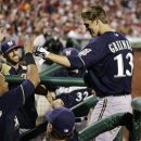 Milwaukee Brewers starting pitcher Zack Greinke is greeted in the dugout after hitting a home run off Philadelphia Phillies' Cliff Lee in the seventh inning of a baseball game, Tuesday, July 24, 2012, in Philadelphia. The Phillies won 7-6. (AP Photo/Tom Mihalek)