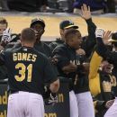 Oakland Athletics' Josh Donaldson, right,  and Jonny Gomes (31) celebrate Donaldson's two-run home run hit off Boston Red Sox's Aaron Cook in the second inning of a baseball game Friday, Aug. 31, 2012, in Oakland, Calif. (AP Photo/Ben Margot)