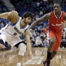 Minnesota Timberwolves' Ricky Rubio of Spain, left, maintains his balance as he drives past Los Angeles Clippers' Eric Bledsoe in the first half of an NBA basketball game Wednesday, Jan. 30, 2013 in Minneapolis. (AP Photo/Jim Mone)