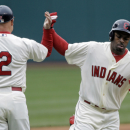 Cleveland Indians' Michael Bourn, right, celebrates his solo home run off Chicago White Sox starting pitcher Jake Peavy with third base coach Brad Mills (2) in the first inning of a baseball game on Sunday, April 14, 2013, in Cleveland. (AP Photo/Mark Duncan)