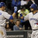 Toronto Blue Jays' J.P. Arencibia, left, greets Jose Bautista at home after Bautista's home run off Chicago White Sox starting pitcher Jose Quintana during the sixth inning of a baseball game, Wednesday, June 6, 2012 in Chicago. (AP Photo/Charles Rex Arbogast)