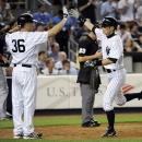 New York Yankees' Ichiro Suzuki, right, celebrates with teammate Kevin Youkilis while scoring on a single by Brett Gardner during the seventh inning of a baseball game against the Boston Red Sox, Friday, May 31, 2013, at Yankee Stadium in New York. (AP Photo/Bill Kostroun)
