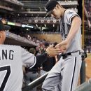 Chicago White Sox coach Joe McEwing, left, congratulates pitcher Chris Sale after the fifth inning of a baseball game against the Minnesota Twins on Friday, Sept. 14, 2012, in Minneapolis. Sale gave up three hits in his six innings of work. (AP Photo/Jim Mone)