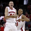 Wiscosin's Jared Berggren, left, and George Marshall celebrate a three-point basket by teammate Ben Brust during the first half of an NCAA college basketball game against Illinois, Saturday, Jan. 12, 2013, in Madison, Wis. Berggren had a team-high 15 points in Wisconsin's 74-51 upset over Illinois. (AP Photo/Andy Manis)