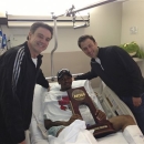 In this photo released by the University of Louisville, injured Louisville guard Kevin Ware lies in a hospital bed holding the NCAA Regional Championship trophy flanked by coach Rick Pitino, left, and former Louisville assistant coach Richard Pitino, Monday, April 1, 2013, in Louisville, Ky. Ware broke his leg in the first half of Sunday's Midwest Regional final when he landed awkwardly after trying to contest a 3-point shot, breaking his leg in two places. He was taken off the court on a stretcher as his stunned teammates openly wept. His teammates went on to defeat Duke 85-63 to reach their second straight Final Four. (AP Photo/University of Louisville, Kenny Klein)