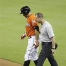 Miami Marlins' Giancarlo Stanton, left, is led off the field by team trainer Sean Cunningham, right, after straining his right hamstring in the ninth inning during a baseball game against the New York Mets, Monday, April, 29, 2013 in Miami. The Marlins defeated the Mets 4-3 in fifteen innings.(AP Photo/Lynne Sladky)