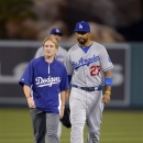 CORRECTS ID OF TRAINER TO ASSISTANT ATHLETIC TRAINER NANCY PATTERSON INSTEAD OF SUE FALSONE - Los Angeles Dodgers center fielder Matt Kemp, right, walks off the field with assistant athletic trainer Nancy Patterson during the seventh inning of their baseball game against the Los Angeles Angels, Wednesday, May 29, 2013, in Anaheim, Calif. The Angels won 4-3. (AP Photo/Mark J. Terrill)