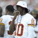 Washington Redskins quarterback Robert Griffin III (10) looks on from the sidelines in the second half of an NFL preseason football game against the Buffalo Bills, Saturday, Aug. 24, 2013, in Landover, Md. (AP Photo/Nick Wass)