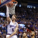 Kansas center Jeff Withey (5) dunks after getting past TCU forward Adrick McKinney (24) during the first half of an NCAA college basketball game in Lawrence, Kan., Saturday, Feb. 23, 2013. (AP Photo/Orlin Wagner)