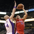 Los Angeles Clippers' Blake Griffin (32) drives to the basket past Phoenix Suns' Marcin Gortat of Poland during the first half of an NBA basketball game Sunday, Dec. 23, 2012, in Phoenix. (AP Photo/Ralph Freso)