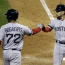 Boston Red Sox's Shane Victorino is congratulated by Xander Bogaerts after Victorino scored during the eighth inning of Game 3 of baseball's World Series against the St. Louis Cardinals Saturday, Oct. 26, 2013, in St. Louis. (AP Photo/Charlie Neibergall)