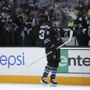 San Jose Sharks center Joe Pavelski (8) is high-fived by teammates after scoring a goal against the Edmonton Oilers during the second period of an NHL hockey game in San Jose, Calif., Thursday, Jan. 31, 2013. (AP Photo/Tony Avelar)