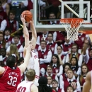 Indiana's Will Sheehey (0) is fouled by Nebraska's Andre Almeida (32) as he dunks the ball during the first half of an NCAA college basketball game, Wednesday, Feb. 13, 2013, in Bloomington, Ind. (AP Photo/Doug McSchooler)