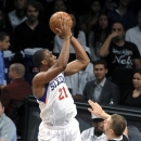 Philadelphia 76ers' Thaddeus Young (21) leaps over Brooklyn Nets' Mirza Teletovic (33) during the first half on an NBA preseason basketball game Friday, Oct. 19, 2012, in New York. (AP Photo/Kathy Kmonicek)