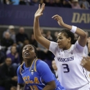 Washington's Talia Walton (3) defends as UCLA's Jasmine Dixon shoots in the first half of an NCAA college basketball game Friday, Feb. 8, 2013, in Seattle. (AP Photo/Elaine Thompson)
