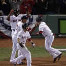 Boston Red Sox's Jacoby Ellsbury, front, Xander Bogaerts, and David Ortiz, back, celebrate after Jonny Gomes, right, scored during the third inning of Game 6 of baseball's World Series against the St. Louis Cardinals Wednesday, Oct. 30, 2013, in Boston. (AP Photo/Charlie Riedel)
