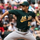 Oakland Athletics starting pitcher Tommy Milone throws to the Chicago White Sox during the first inning in a baseball game on Saturday, June 8, 2013.(AP Photo/Charles Cherney)