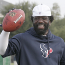 Houston Texans free safety Ed Reed smiles as he tosses back a football during the team's NFL football training camp Saturday, July 27, 2013, in Houston. A standout All-Pro, Reed joined the Texans after last season's Super Bowl run in Baltimore. (AP Photo/Pat Sullivan)