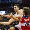 Toronto Raptors forward Andrea Bargnani, left, drives past Washington Wizards forward Jan Vesely, right, during the first half of their preseason NBA basketball game, Wednesday, Oct. 17, 2012, in Toronto. (AP Photo/The Canadian Press, Nathan Denette)