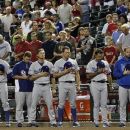 Los Angeles Dodgers players and coaches pause for a moment of silence to honor and remember those who were killed in the Sept. 11, 2001, terrorist attacks prior to a baseball game against the Arizona Diamondbacks, Tuesday, Sept. 11, 2012, in Phoenix. (AP Photo/Ross D. Franklin)