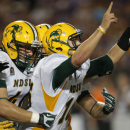 North Dakota State quarterback Brock Jensen (16) celebrates his game winning touchdown with fullback Andrew Grothmann (40) during the second half of an NCAA college football game against the Kansas State in Manhattan, Kan., Friday, Aug. 30, 2013. North Dakota State defeated Kansas State 24-21. (AP Photo/Orlin Wagner)
