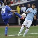 Chelsea defender Cesar Azpilicueta, left, and Manchester City forward Carlos Tevez compete for the ball during the first half of an exhibition international friendly soccer match on Saturday, May 25, 2013, at Yankee Stadium in New York. (AP Photo/Julio Cortez)